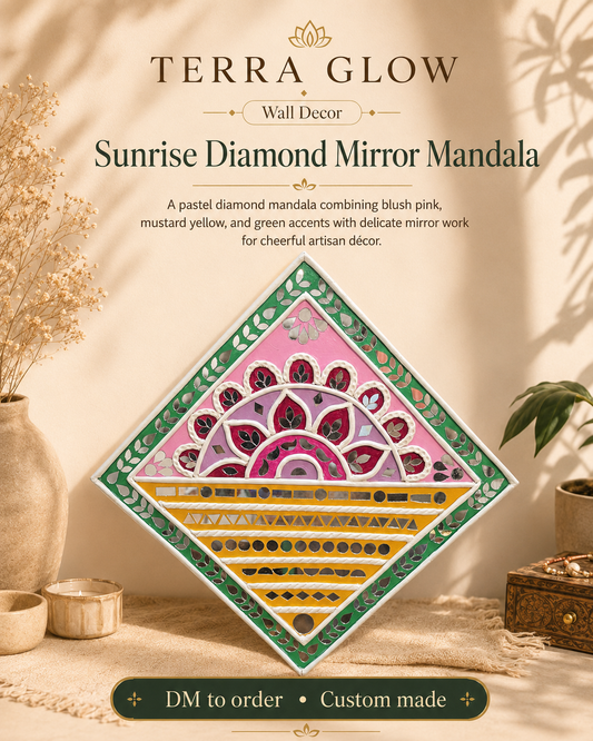 A diamond-shaped decorative mirror mandala by Terra Glow, shown hanging on a beige wall in a styled home setting. The mandala features a pastel pink and green central design with yellow and red geometric patterns.