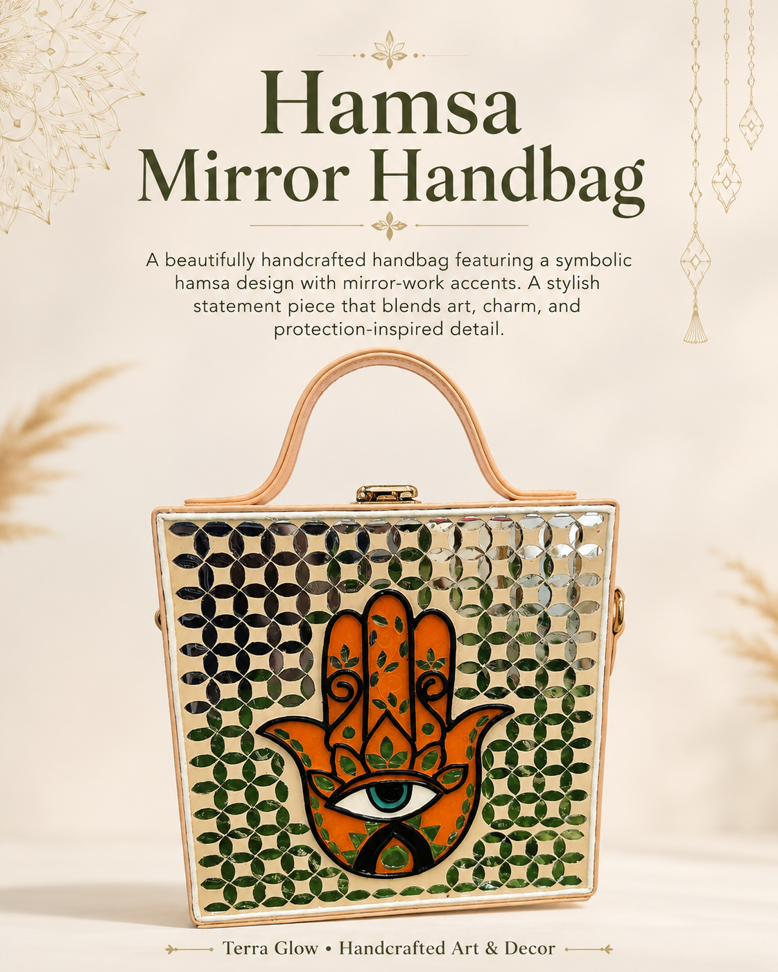 A rectangular hamsa handbag with a mirrored patterned surface and a large orange hamsa hand design with a central eye, shown on a light cream background with decorative text above reading 'Hamsa Mirror Handbag.'.