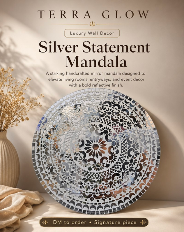 A round silver mirrored mandala wall decor piece displayed against a warm beige wall, with decorative dried flowers in a vase and a soft fabric cloth nearby. Text at the top reads 'TERRA GLOW Luxury Wall Decor' and 'Silver Statement Mandala,' with an order note at the bottom.